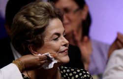 A supporter helps clean Brazil's President Dilma Rousseff's face during the opening ceremony of the National Policy Conference for Women in Brasilia, Brazil, May 10, 2016. REUTERS/Ueslei Marcelino